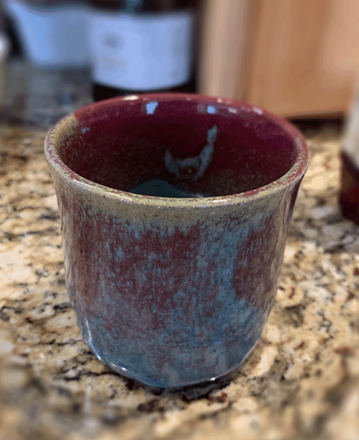 Hand-thrown ceramic cup with red glaze