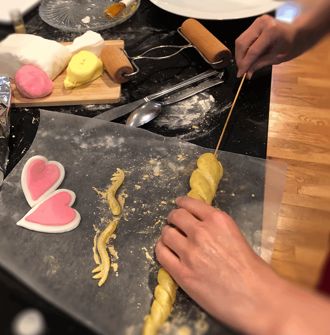 Rolling dough by hand with heart cutouts