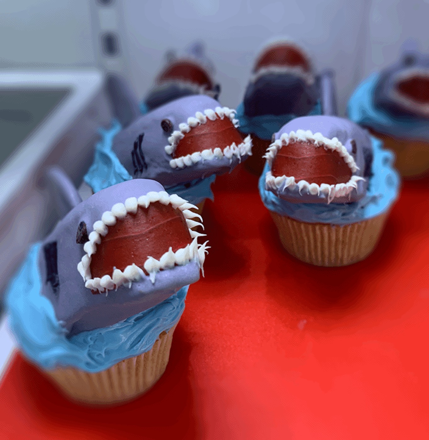 Shark-themed cupcakes with blue frosting