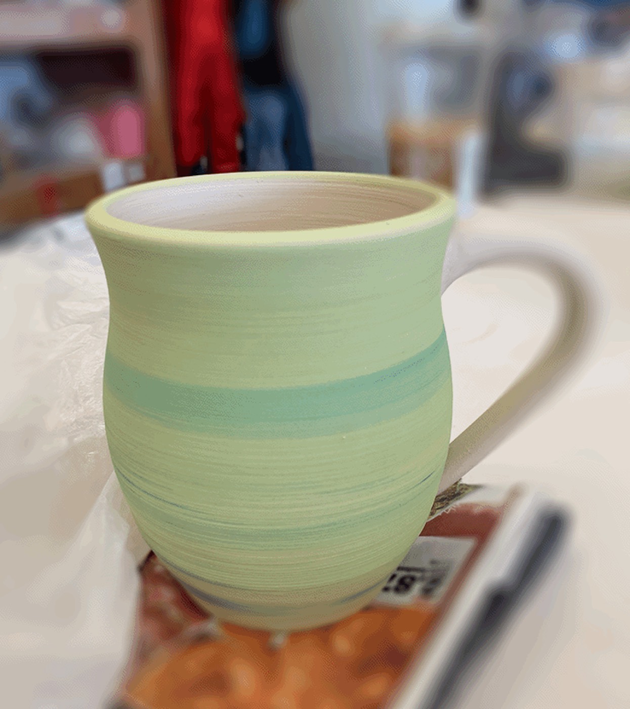 Hand-thrown mug with soft green glaze